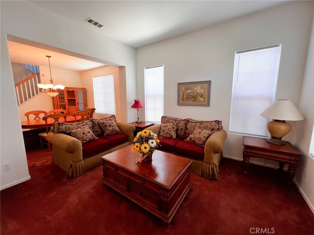 3857 Bella Torre Road Perris, CA 92571 - Photo 5 of 25 a living room with furniture a rug and a large window