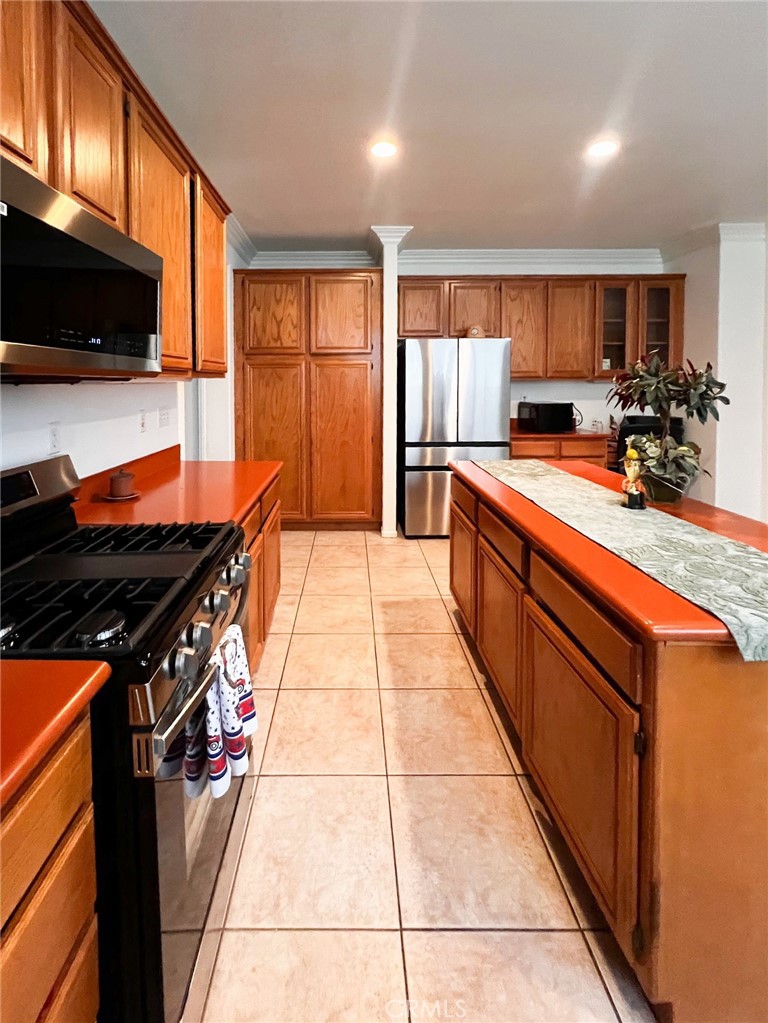 3857 Bella Torre Road Perris, CA 92571 - Photo 9 of 25 a kitchen with stainless steel appliances granite countertop a stove a sink and a microwave