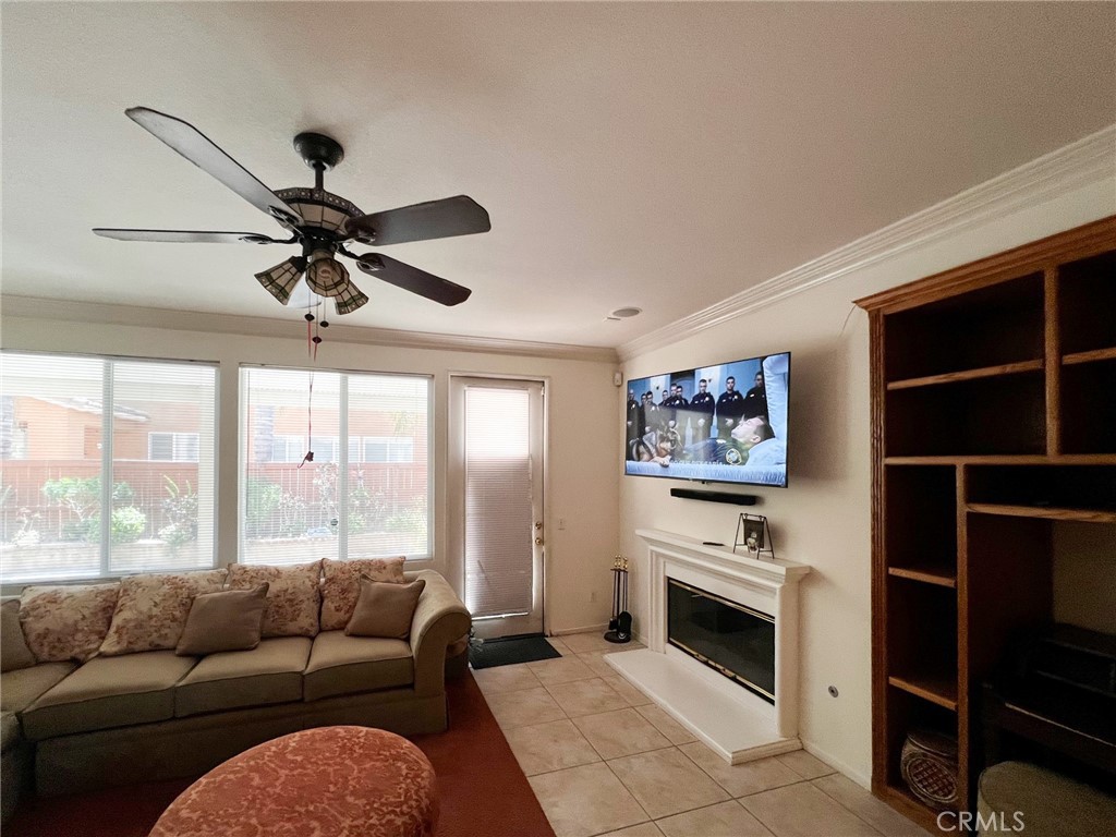 3857 Bella Torre Road Perris, CA 92571 - Photo 10 of 25 a living room with furniture a floor to ceiling window and a flat screen tv