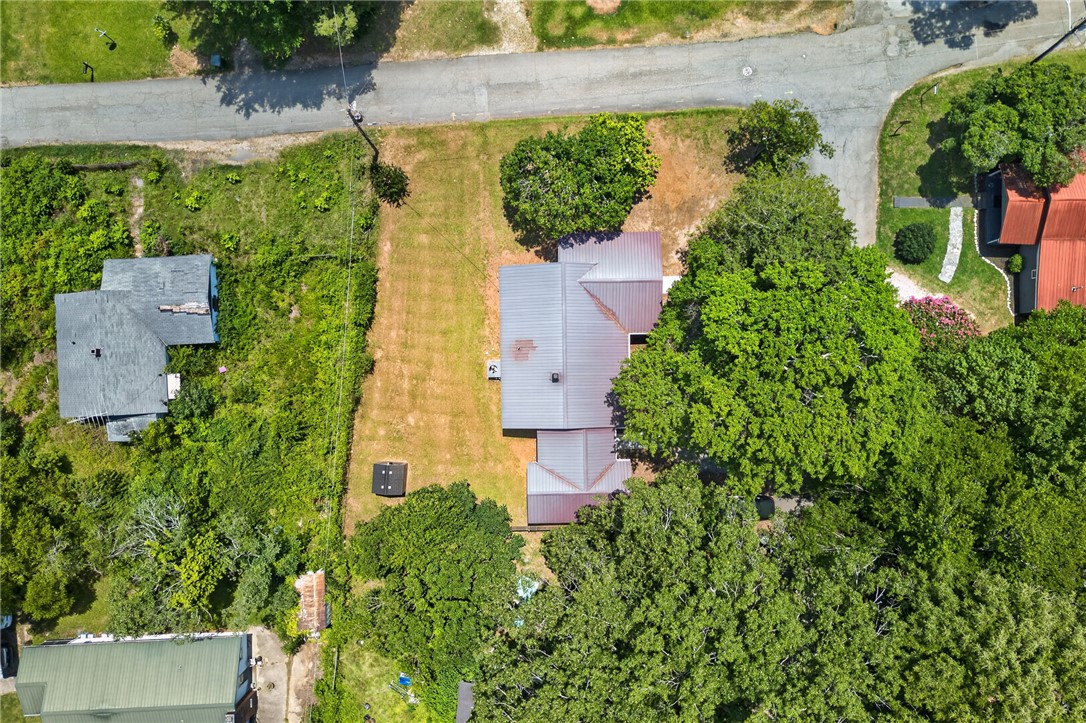 115 Pelfrey Street Seneca, SC 29672 - Photo 43 of 46 An aerial perspective showcases a property with mature trees and a metal roof.