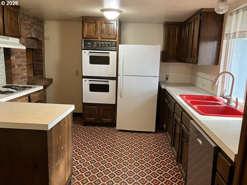 4210 Northeast Breyman Orchards Road Dayton, OR 97114 - Photo 15 of 48 a kitchen with stainless steel appliances a stove a sink and a refrigerator
