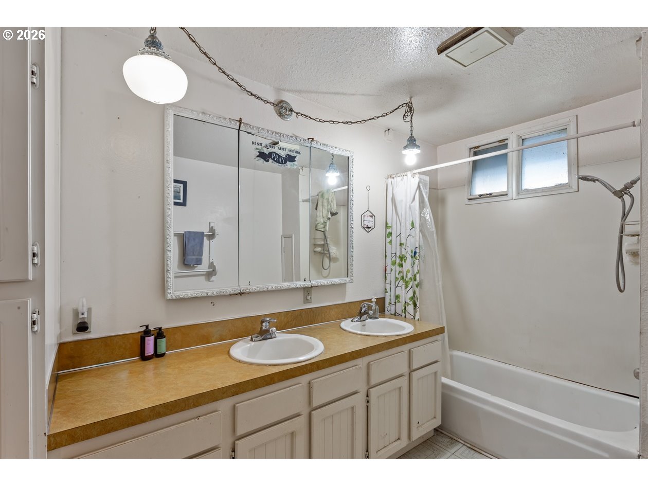 4210 Northeast Breyman Orchards Road Dayton, OR 97114 - Photo 16 of 48 a bathroom with a sink vanity granite tub shower and a mirror