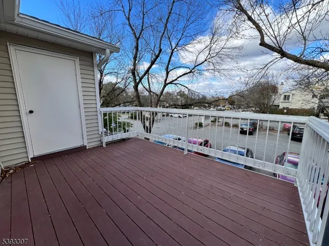 a view of balcony with wooden floor and lake view