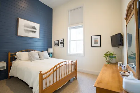 a bedroom with a bed and a night stand