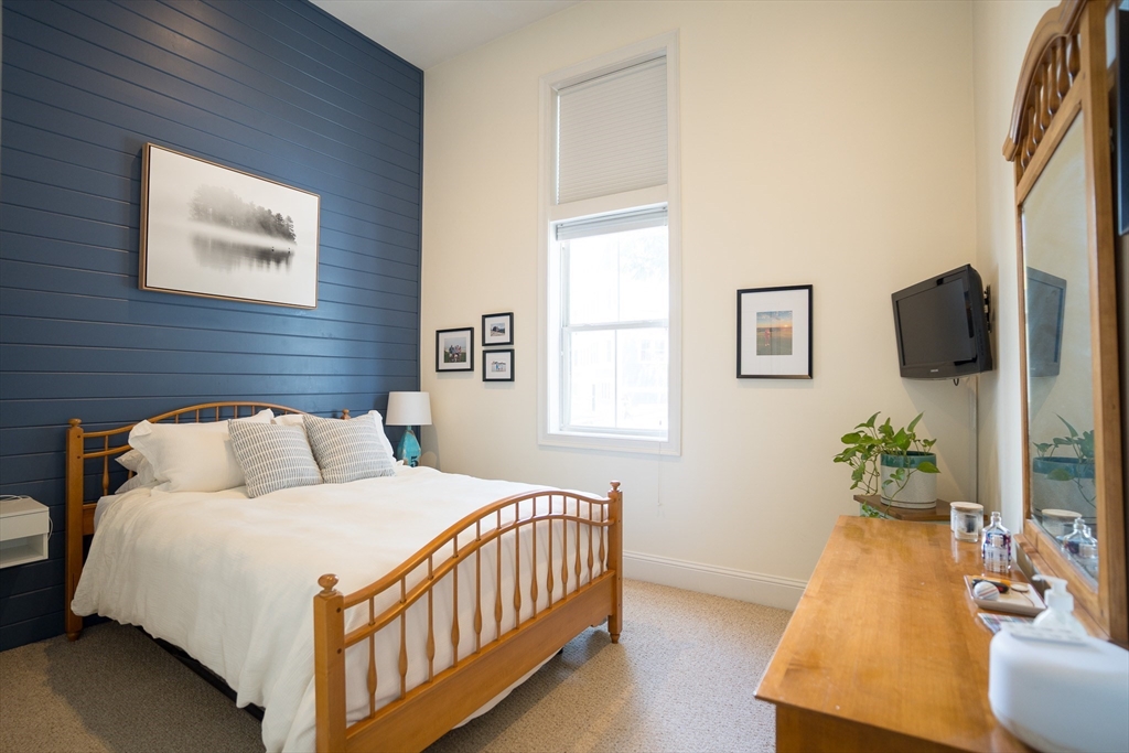 352 West 3rd Street, Unit 9 Boston, MA 02127 - Photo 12 of 18 a bedroom with a bed and a night stand