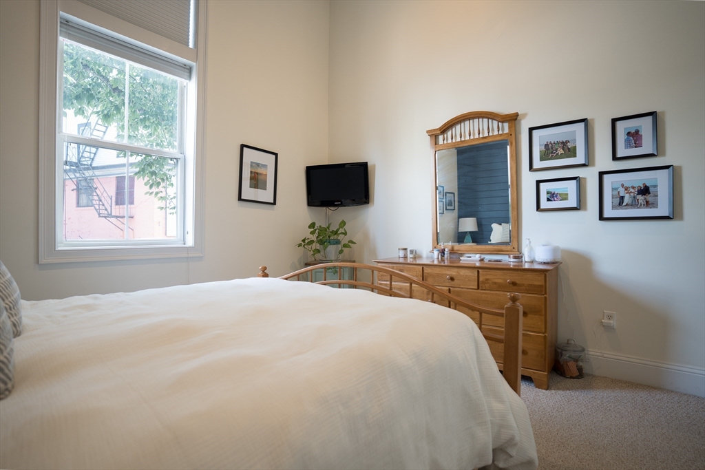 352 West 3rd Street, Unit 9 Boston, MA 02127 - Photo 14 of 18 a bedroom with a bed and a flat screen tv
