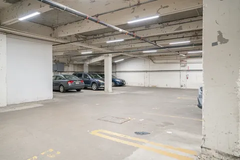 a view of parking garage with cars