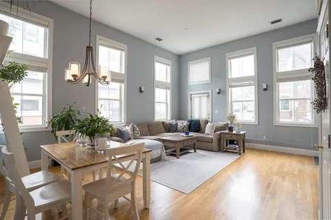 a living room with furniture and large windows