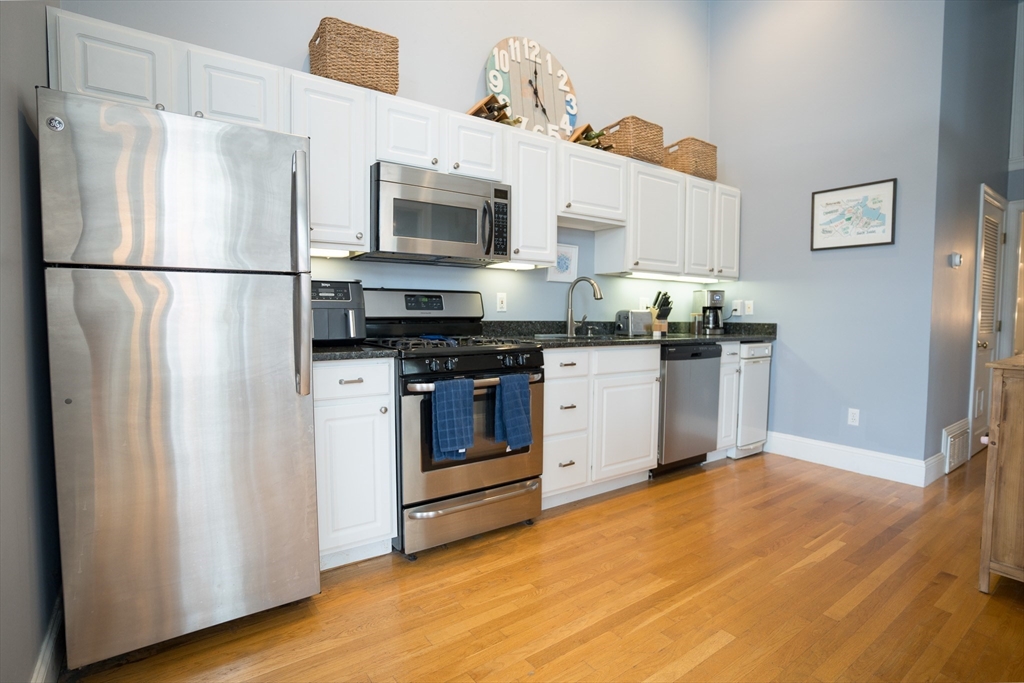 352 West 3rd Street, Unit 9 Boston, MA 02127 - Photo 6 of 18 a kitchen with stainless steel appliances granite countertop a refrigerator sink and stove