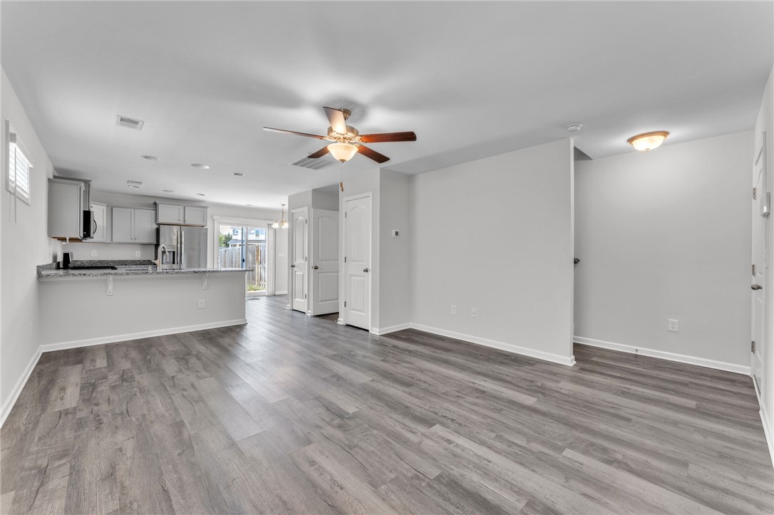 208 Samuel Street Pendleton, SC 29670 - Photo 3 of 32 An open-concept main living area with durable wood-look flooring connects kitchen and living space.