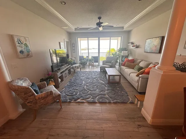 a living room with furniture window and wooden floor