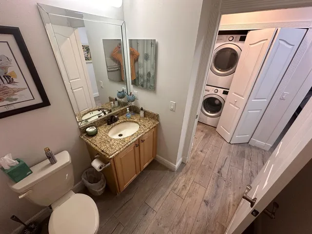 a bathroom with a sink mirror and toilet