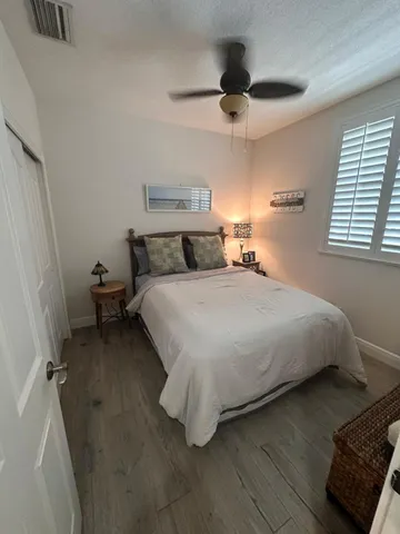 a bedroom with a bed and a large window