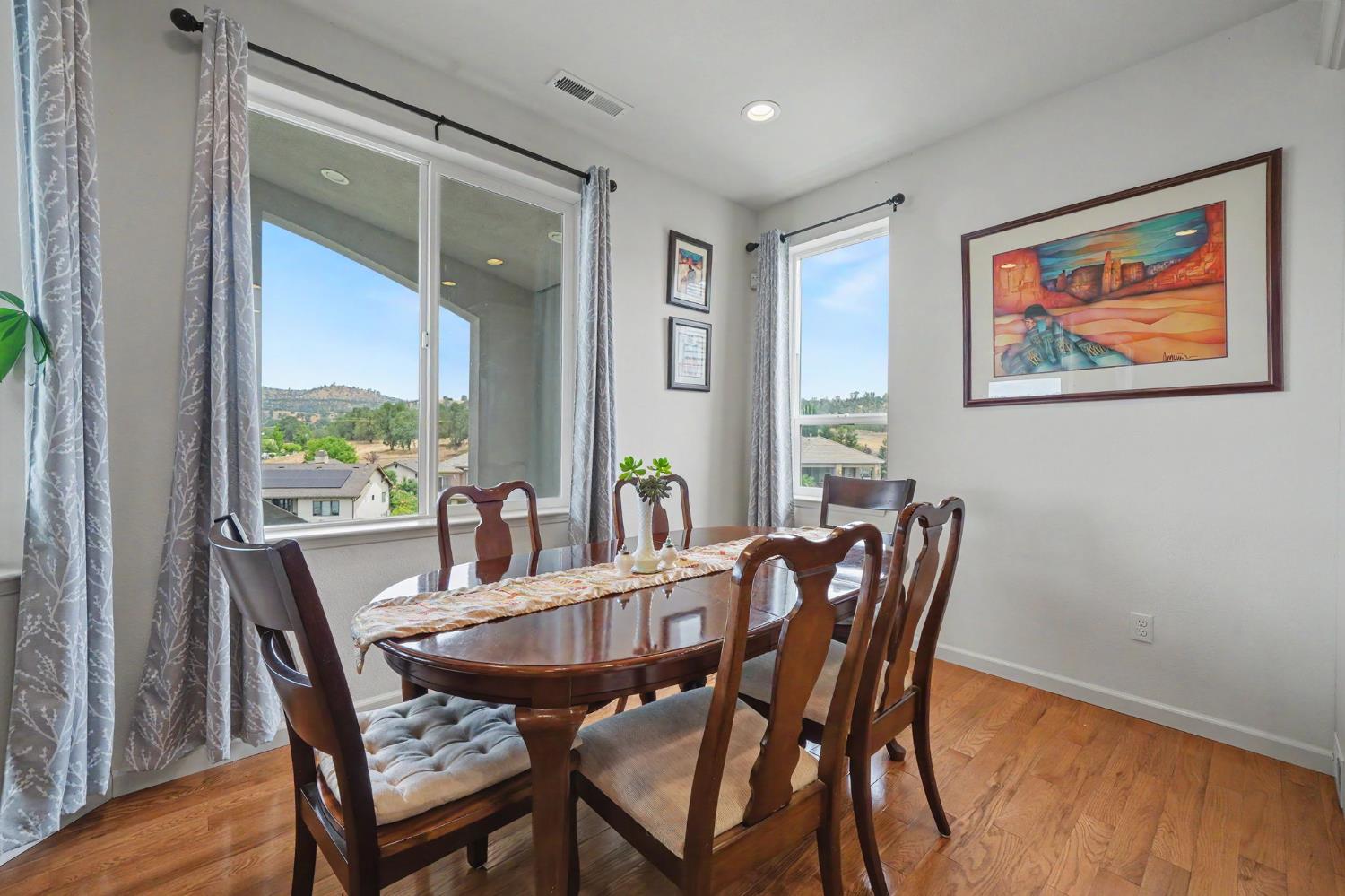 6066 Bluff View Road Copperopolis, CA 95228 - Photo 31 of 96 a view of a dining room with furniture window and wooden floor