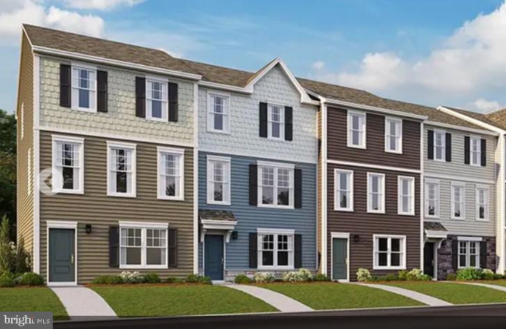 a front view of a residential apartment building with a yard