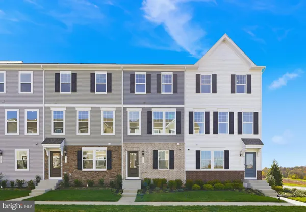 a kitchen with stainless steel appliances granite countertop white cabinets a refrigerator a stove and a sink