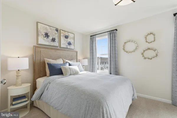 a spacious bedroom with a bed and a window