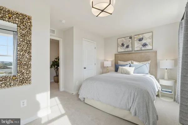 a spacious bedroom with a bed and a mirror