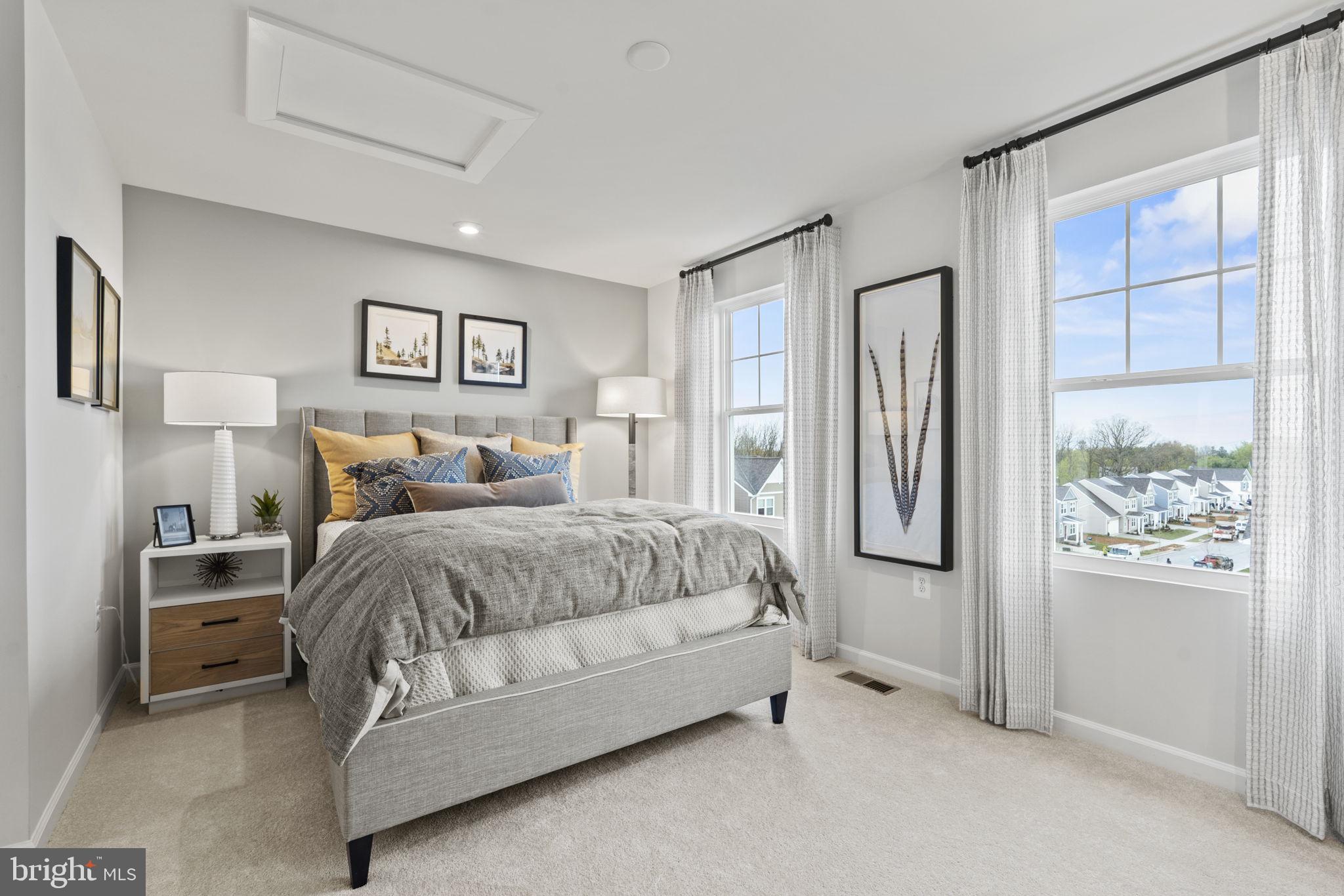 304 Presidents Pointe Avenue, Unit 610 Ranson, WV 25438 - Photo 82 of 87 a spacious bedroom with a bed and a window