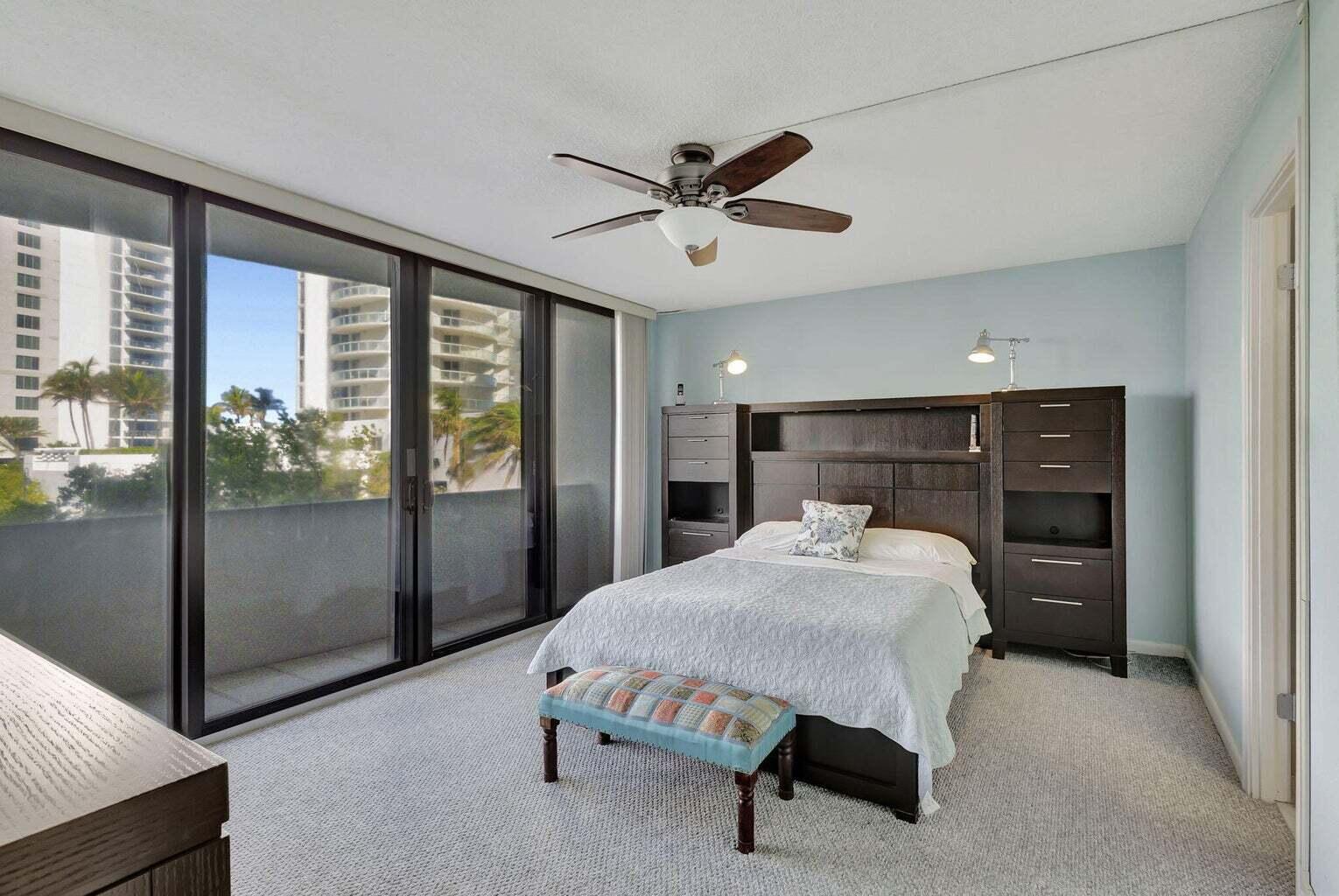 4200 North Ocean Drive, Unit 2201 Singer Island, FL 33404 - Photo 18 of 65 a bed room with a bed and a large window