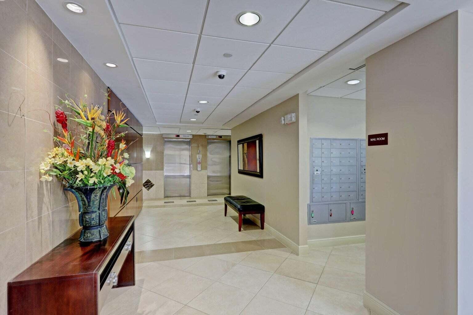4200 North Ocean Drive, Unit 2201 Singer Island, FL 33404 - Photo 38 of 65 a lobby with furniture and flowers