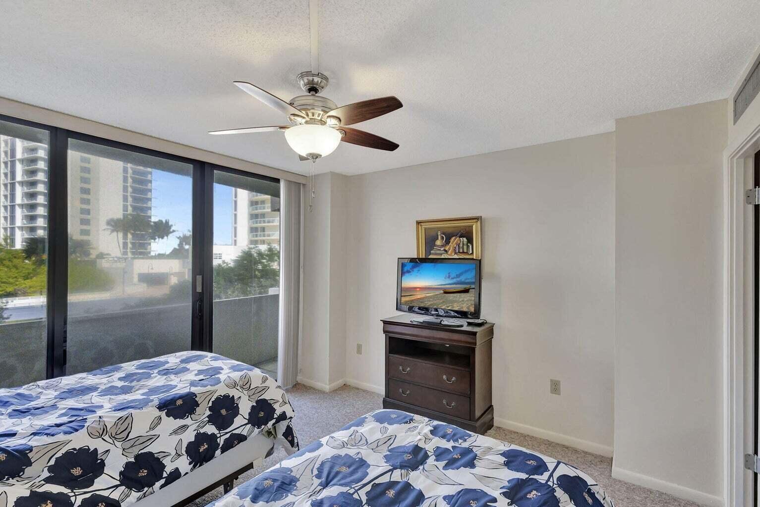 4200 North Ocean Drive, Unit 2201 Singer Island, FL 33404 - Photo 57 of 65 a bedroom with a bed and a window
