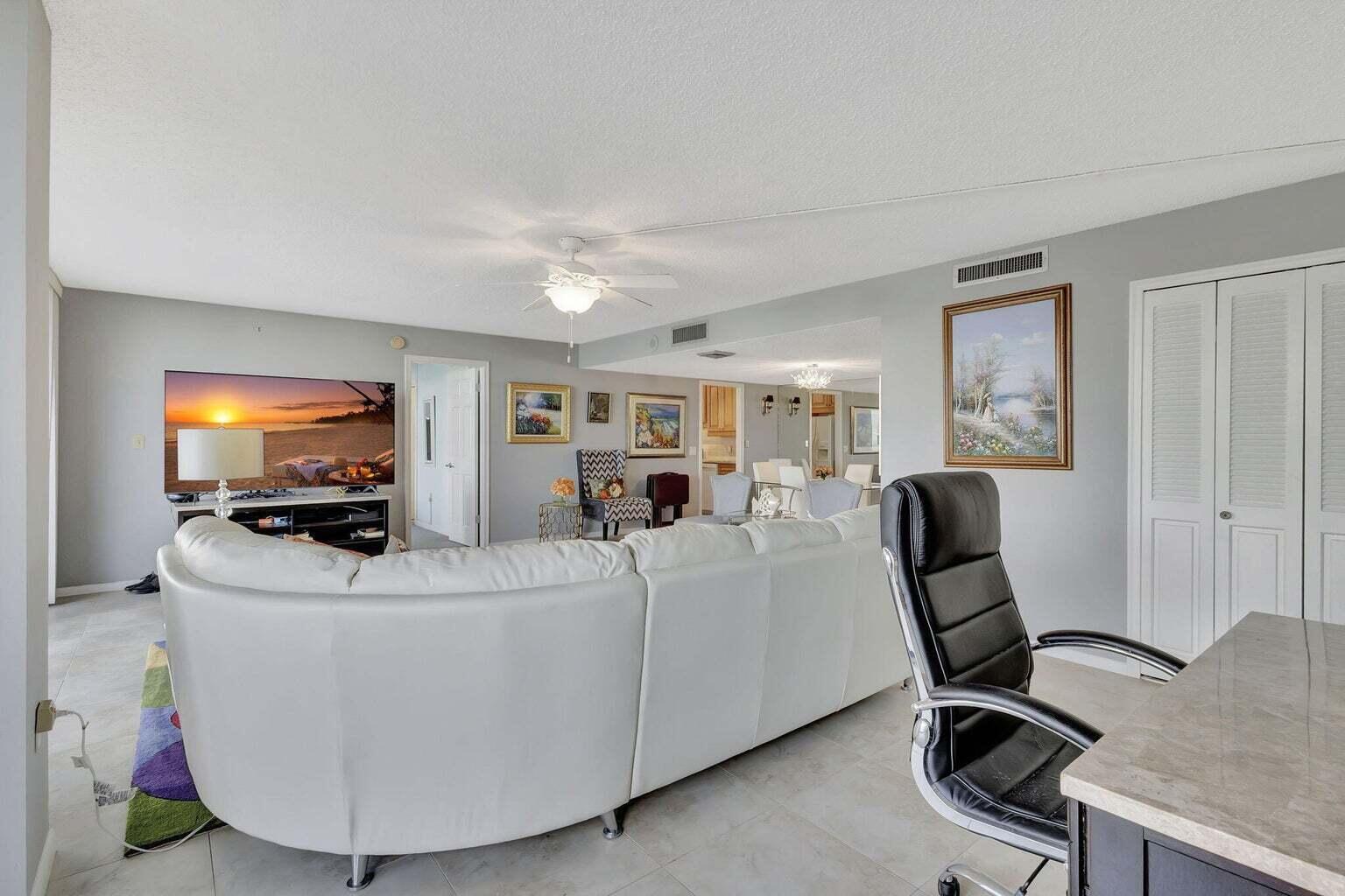 4200 North Ocean Drive, Unit 2201 Singer Island, FL 33404 - Photo 6 of 65 a living room with furniture a flat screen tv and a window
