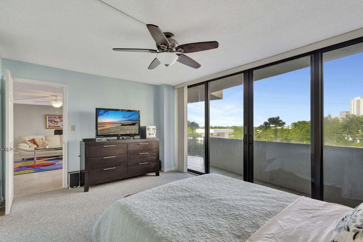 4200 North Ocean Drive, Unit 2201 Singer Island, FL 33404 - Photo 9 of 65 a bedroom with a bed and a flat screen tv