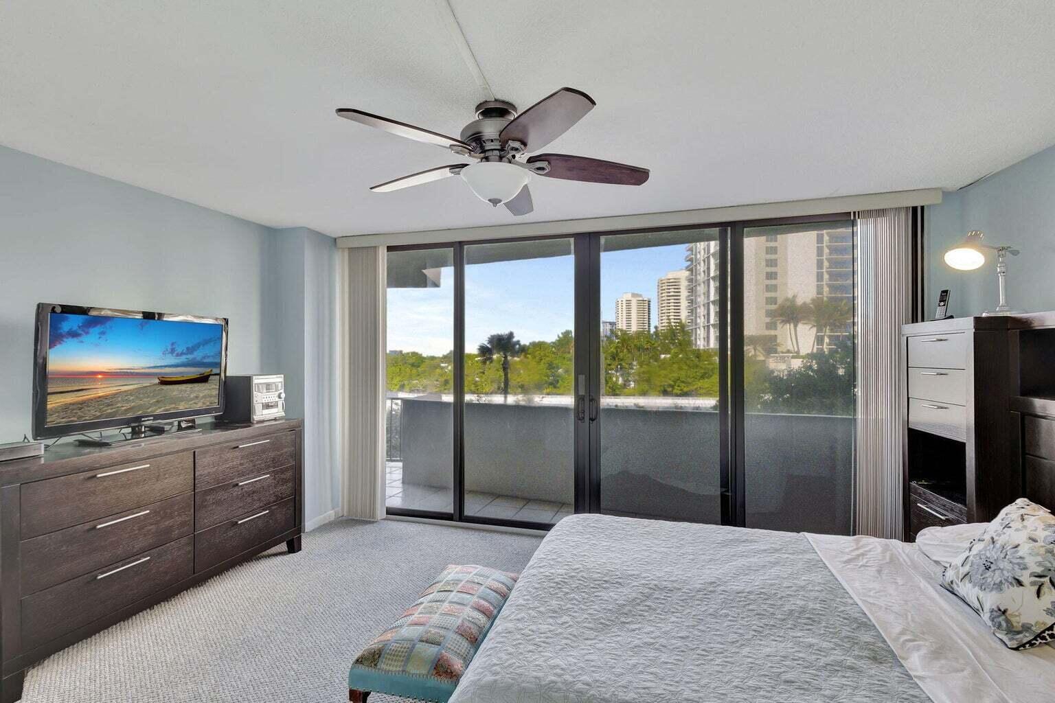 4200 North Ocean Drive, Unit 2201 Singer Island, FL 33404 - Photo 10 of 65 a bedroom with a bed and a flat screen tv