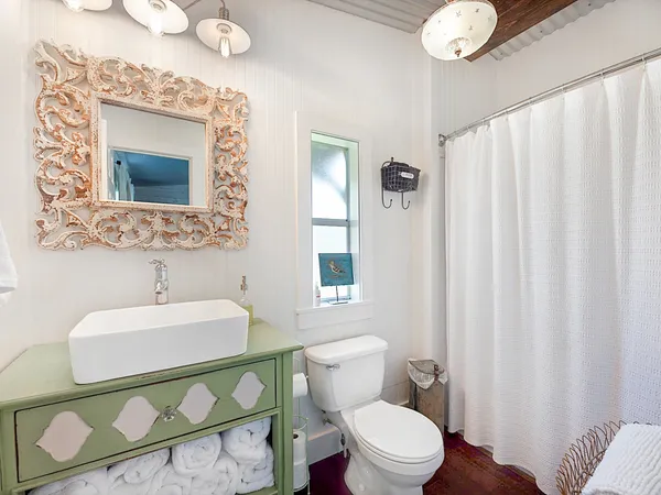 a bathroom with a sink mirror vanity and toilet