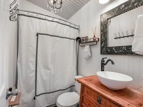 a bathroom with a granite countertop toilet sink and shower