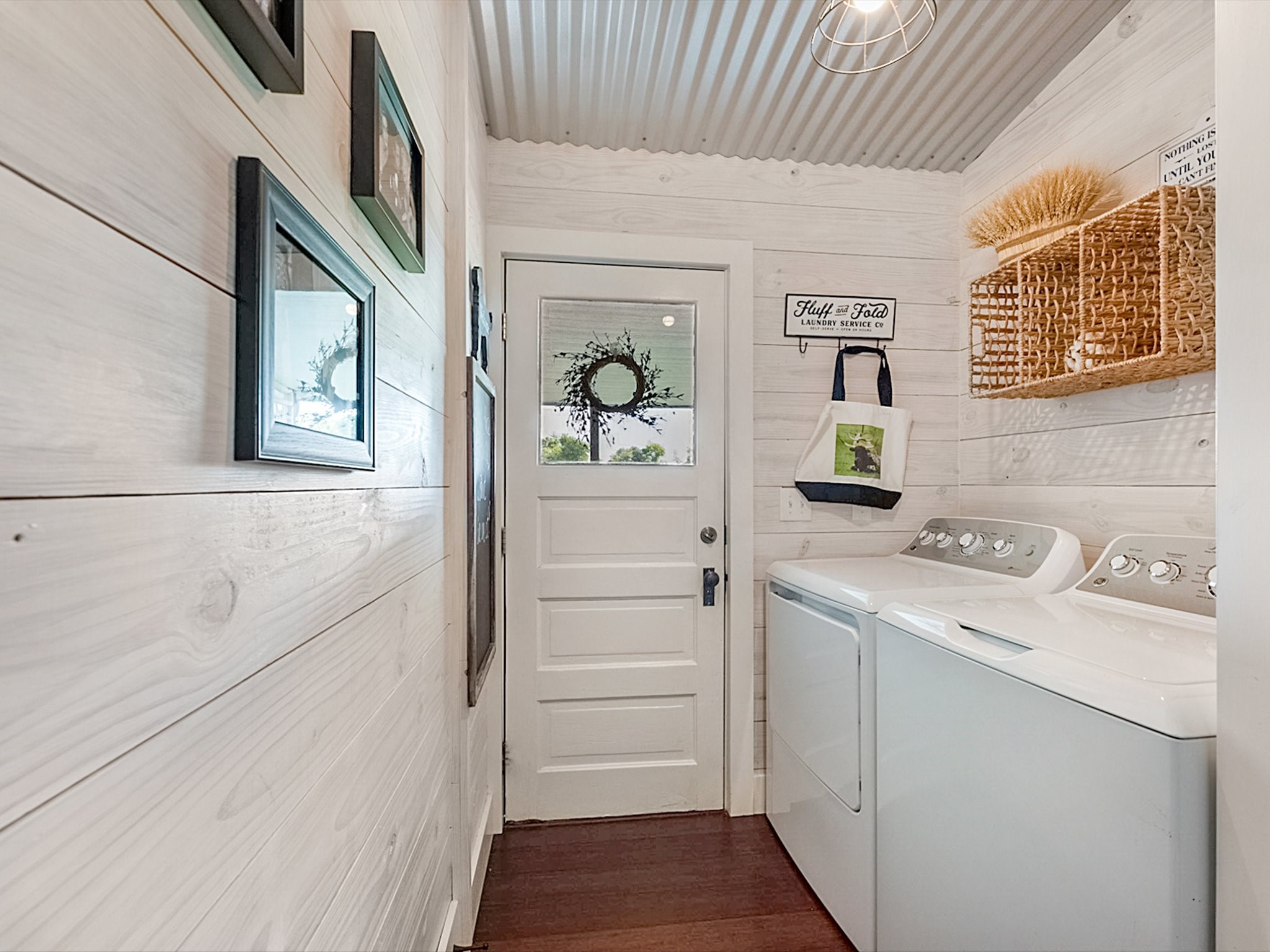 3643 Noak Road Round Top, TX 78954 - Photo 19 of 32 The laundry room is just outside the primary bedroom and kitchen as you head out to the covered back patio and outdoor shower in the Max cabin.