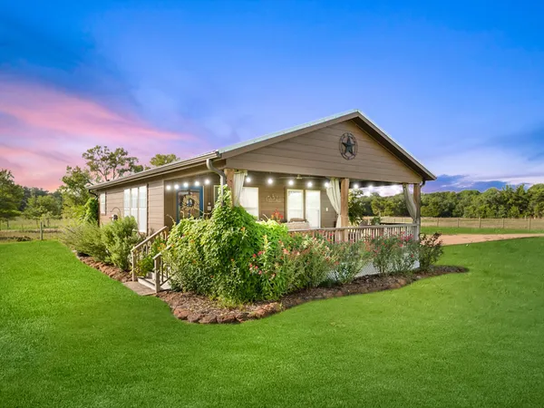 a front view of a house with a garden