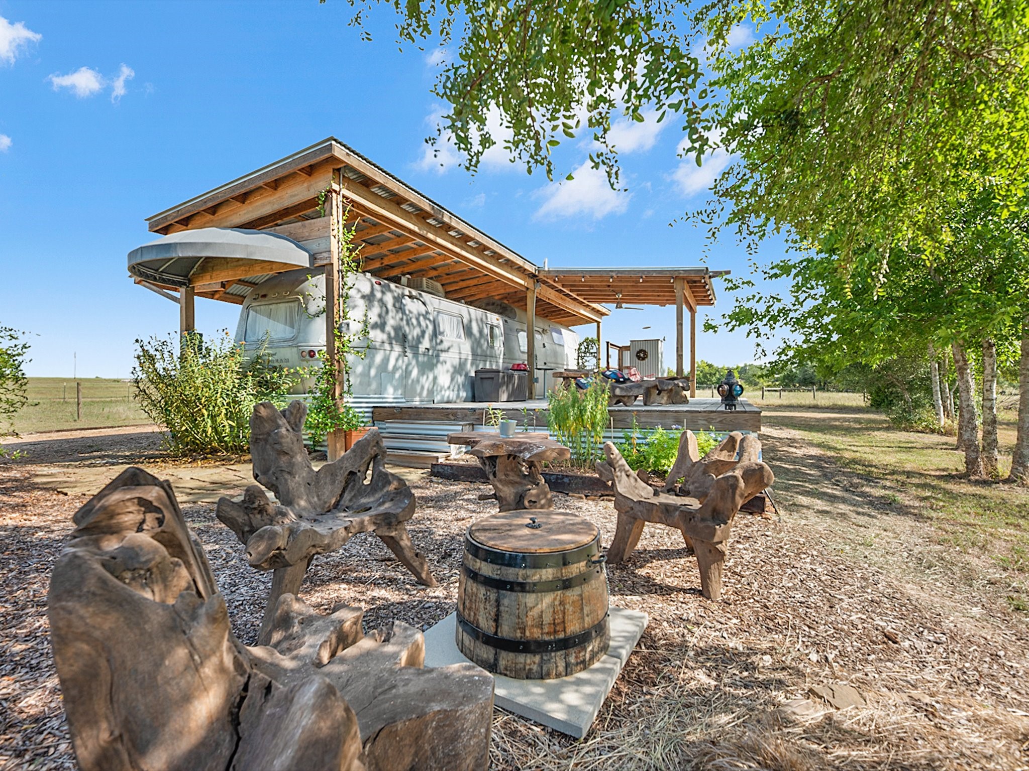 3643 Noak Road Round Top, TX 78954 - Photo 21 of 32 Outdoor seating area in front of the Airstream that overlooks a private pond.