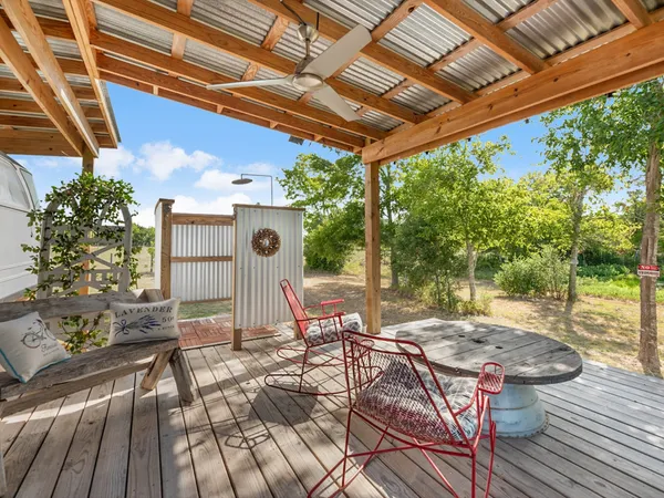 a patio with glass top table and chairs