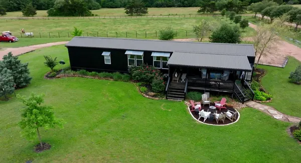 an aerial view of a house with garden space and street view