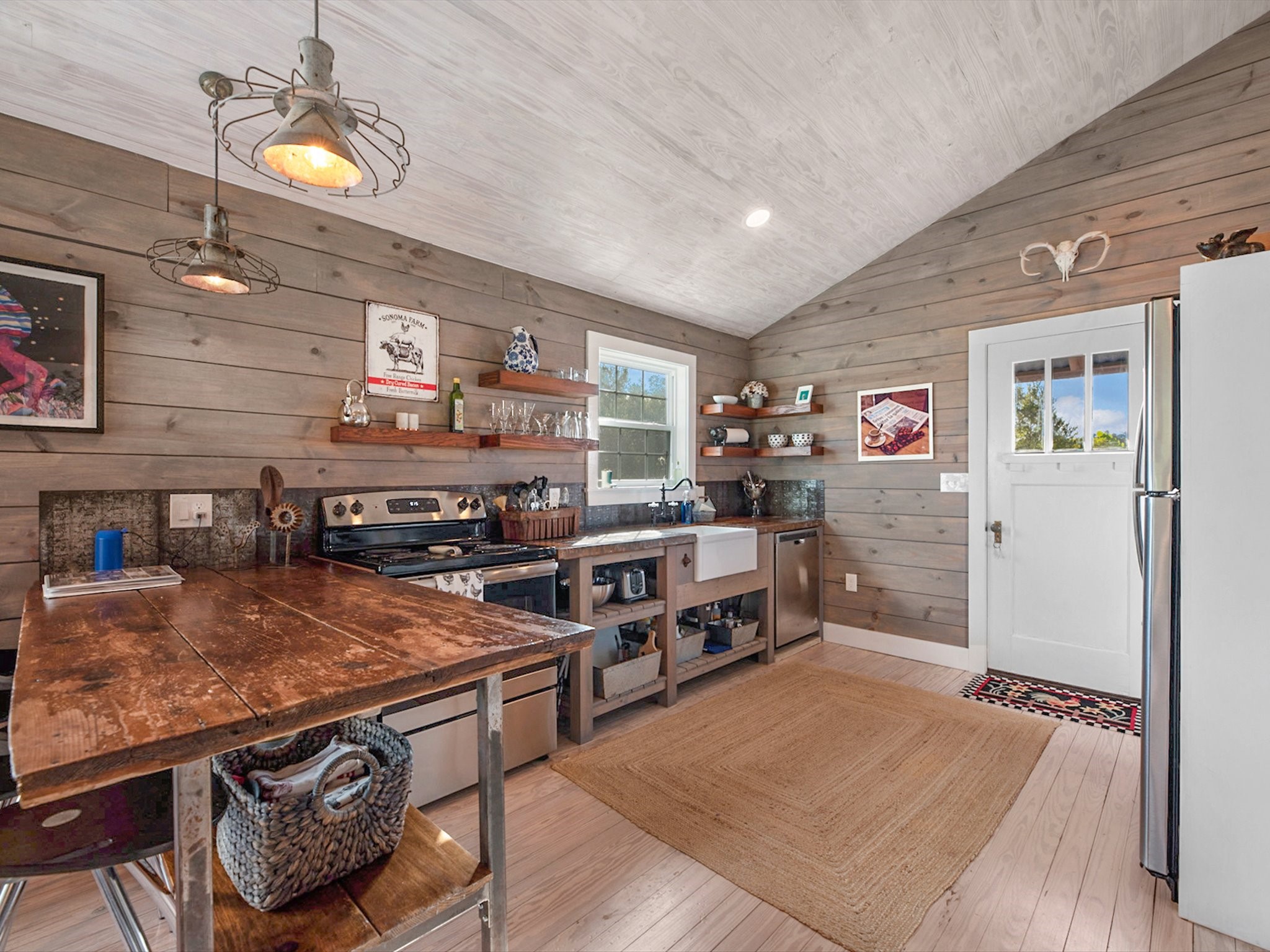 3643 Noak Road Round Top, TX 78954 - Photo 4 of 32 Molly cabin kitchen. Door leads to the outdoor shower and back patio.