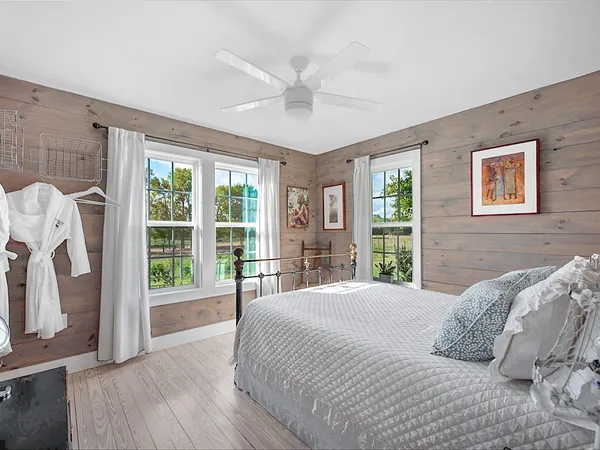 a bedroom with a large bed and a large window