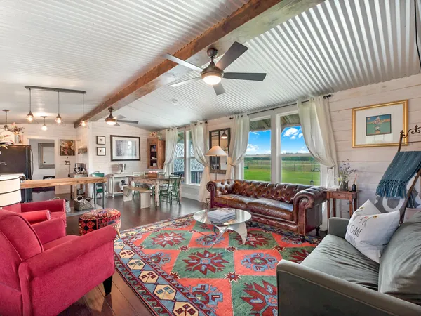 a living room with furniture a large window