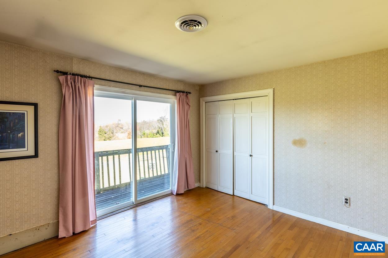 1681 Wilderness Road Reva, VA 22735 - Photo 54 of 72 a view of an empty room with wooden floor and a window