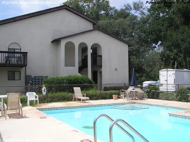 a view of a house with swimming pool and sitting area