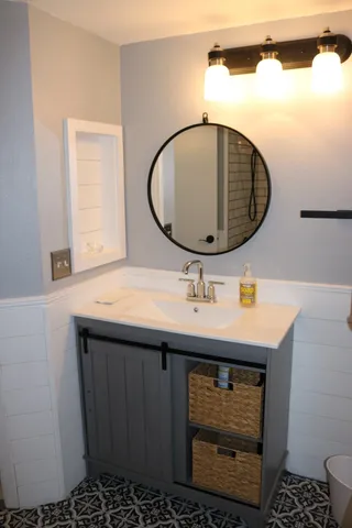 a bathroom with a sink and a mirror