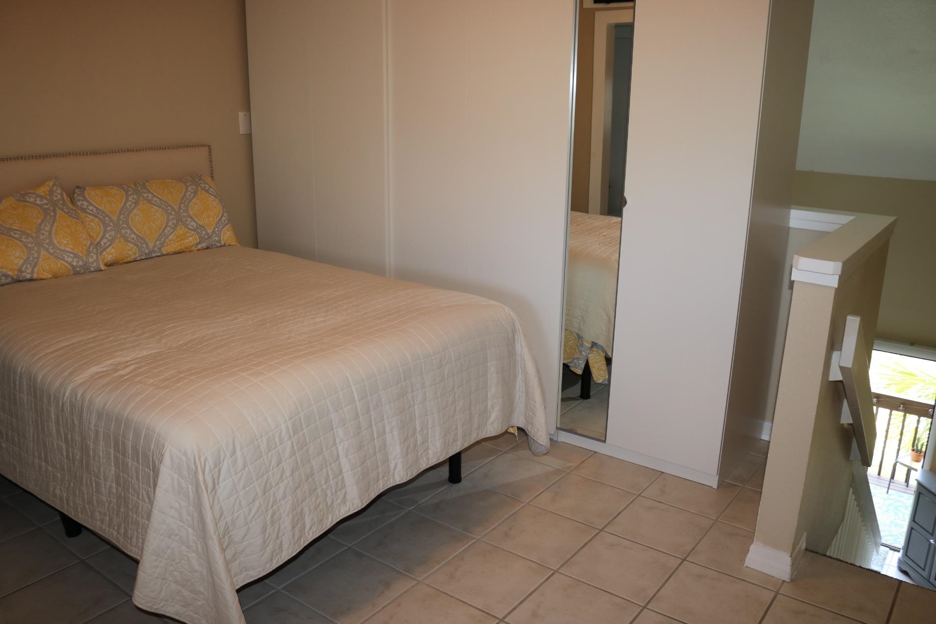 1255 Ponce Island Drive, Unit 768 St. Augustine, FL 32095 - Photo 7 of 14 a large bed in a bedroom next to a window