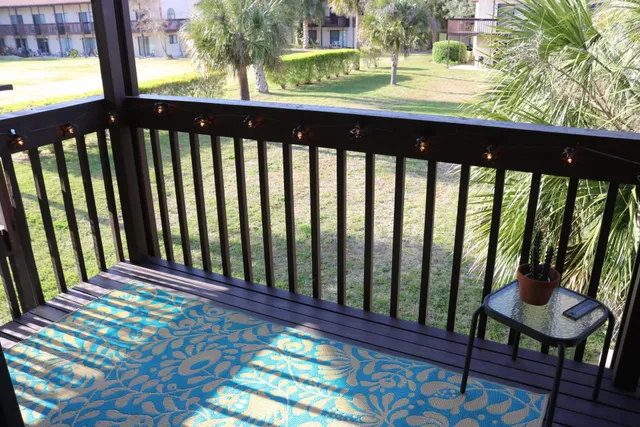 a view of a balcony with wooden floor