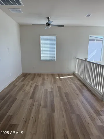 wooden floor in a hall with a window