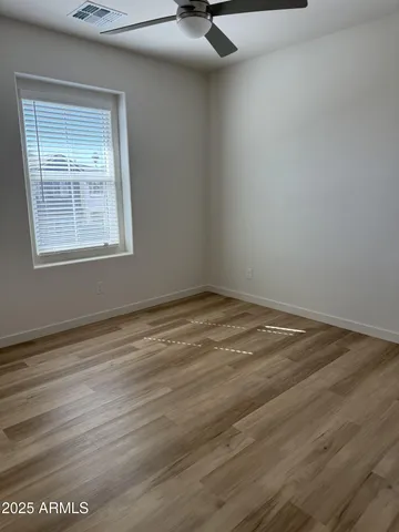 a view of a livingroom with wooden floor and a window
