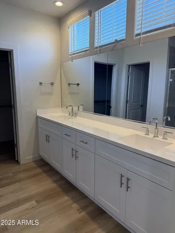 a bathroom with a double vanity sink and a mirror