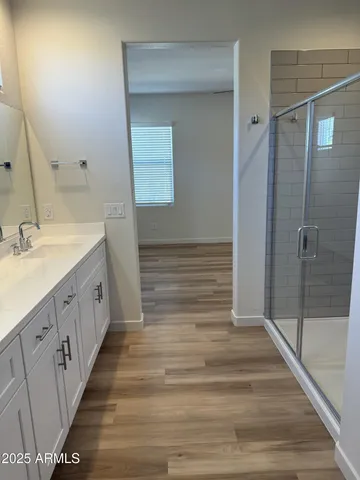 a spacious bathroom with a sink and a mirror