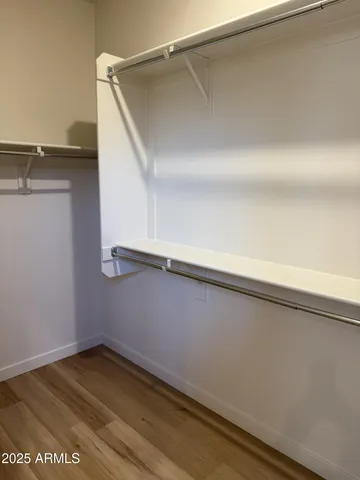 a view of a sink and dishwasher with wooden floor