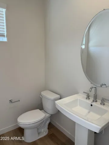 a white toilet sitting next to a bathroom sink